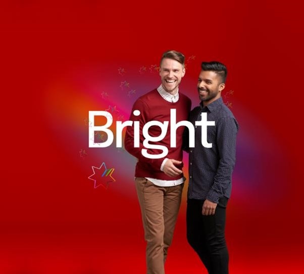 two men standing and smiling