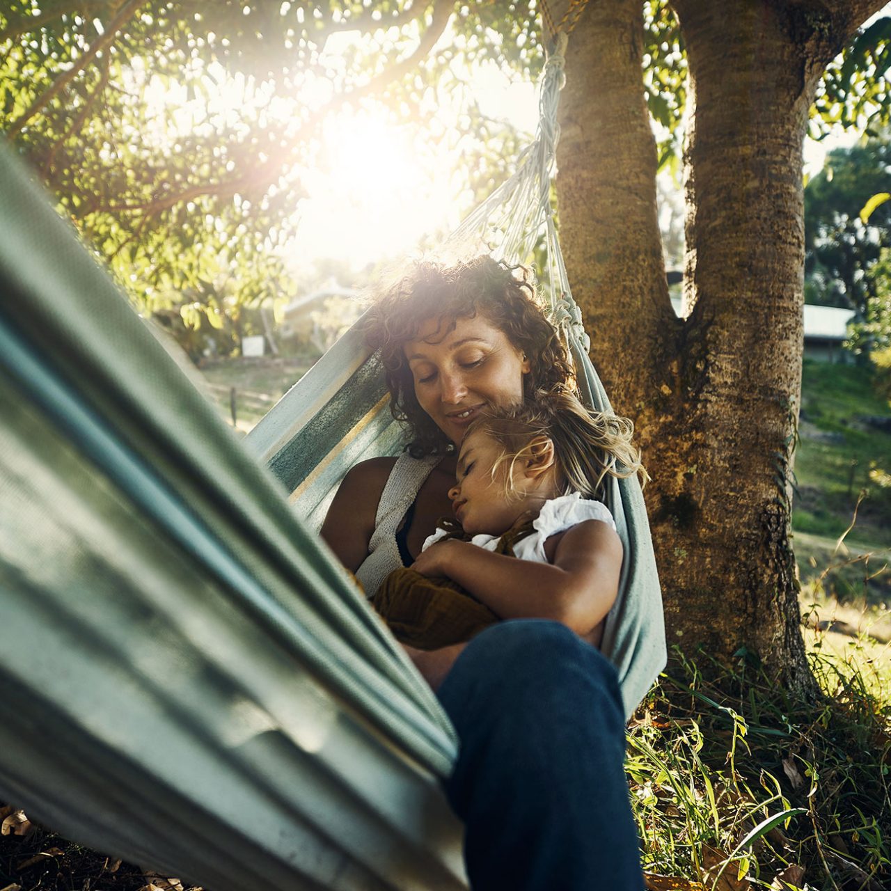 Shot of a mother cuddling her young daughter while they relax in a hammock