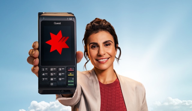 EFTPOS machine with red dessert in the background
