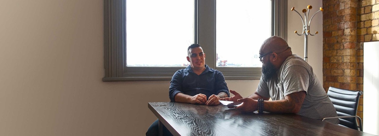 Men talking at table