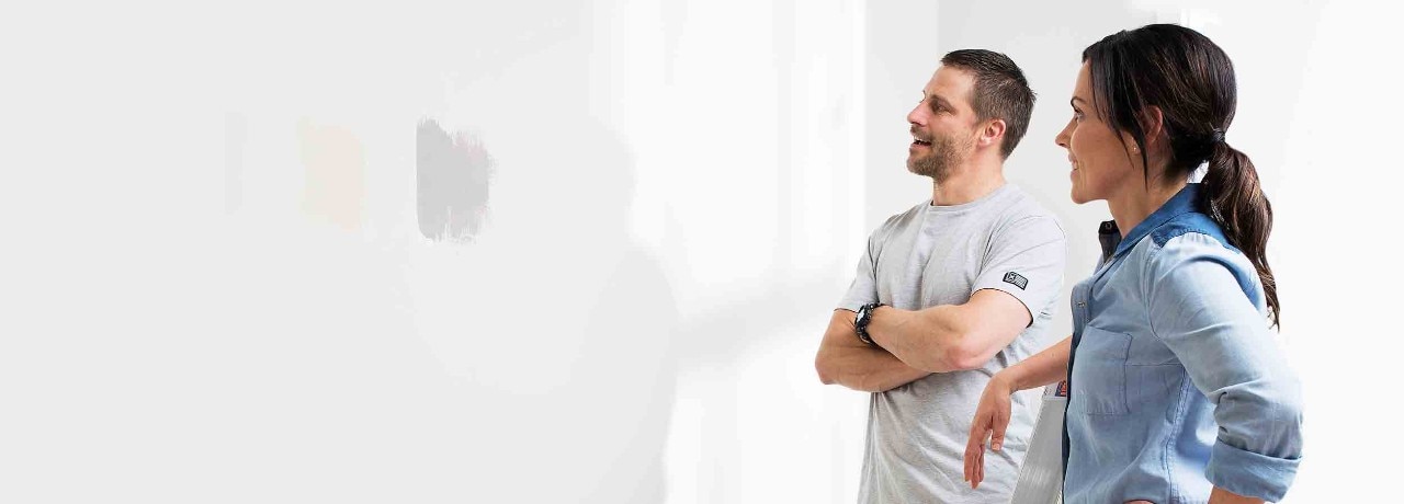 Couple admiring their newly painted wall