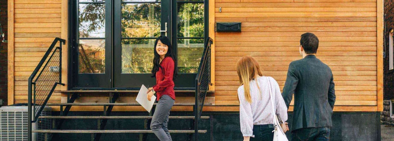 Real Estate: Young couple at a house showing