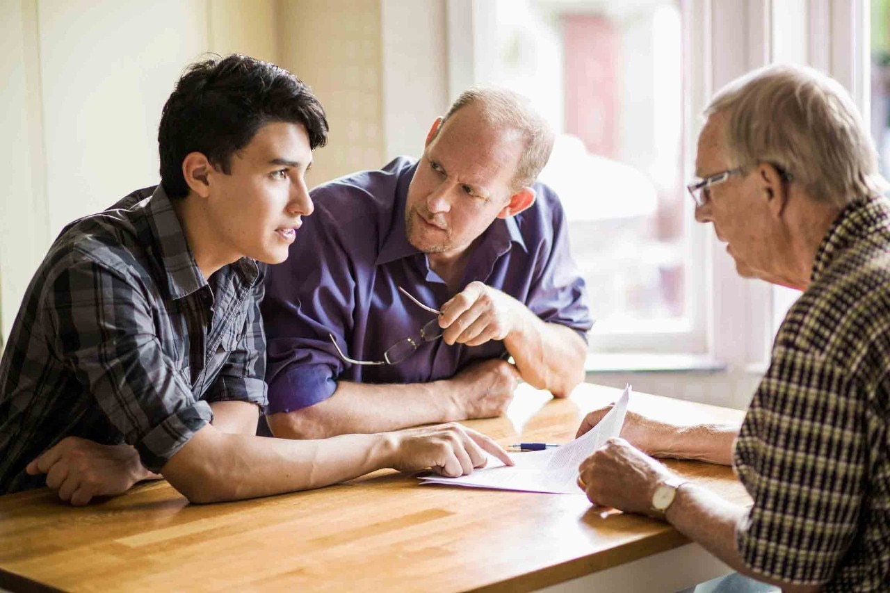 Family discussing over documents at table